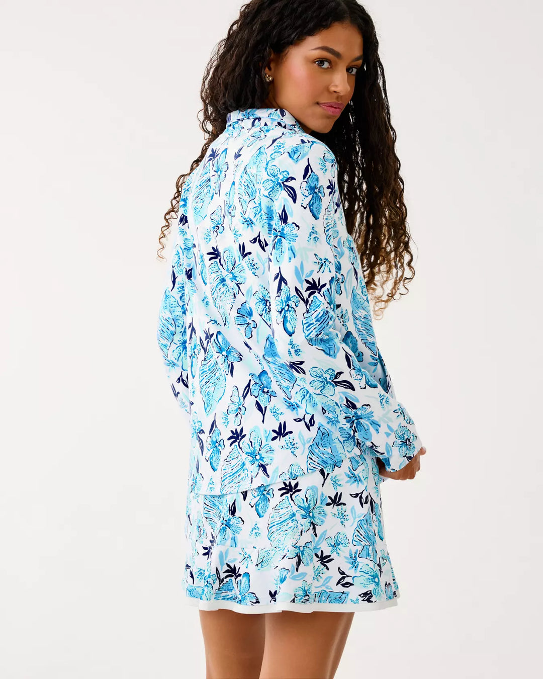 Woman wearing a blue floral dress on a white background
