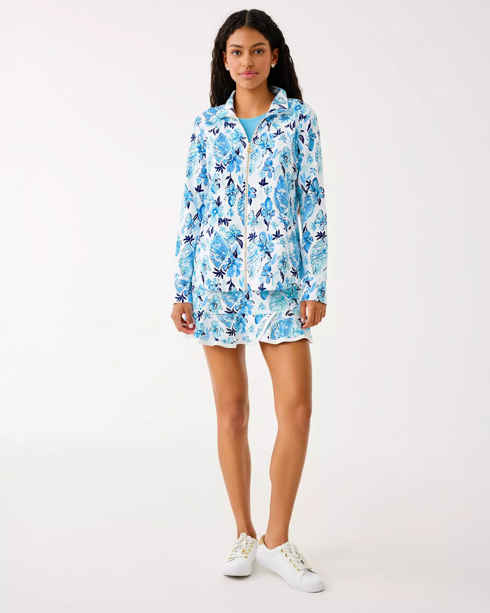 Woman wearing a blue floral dress on a white background