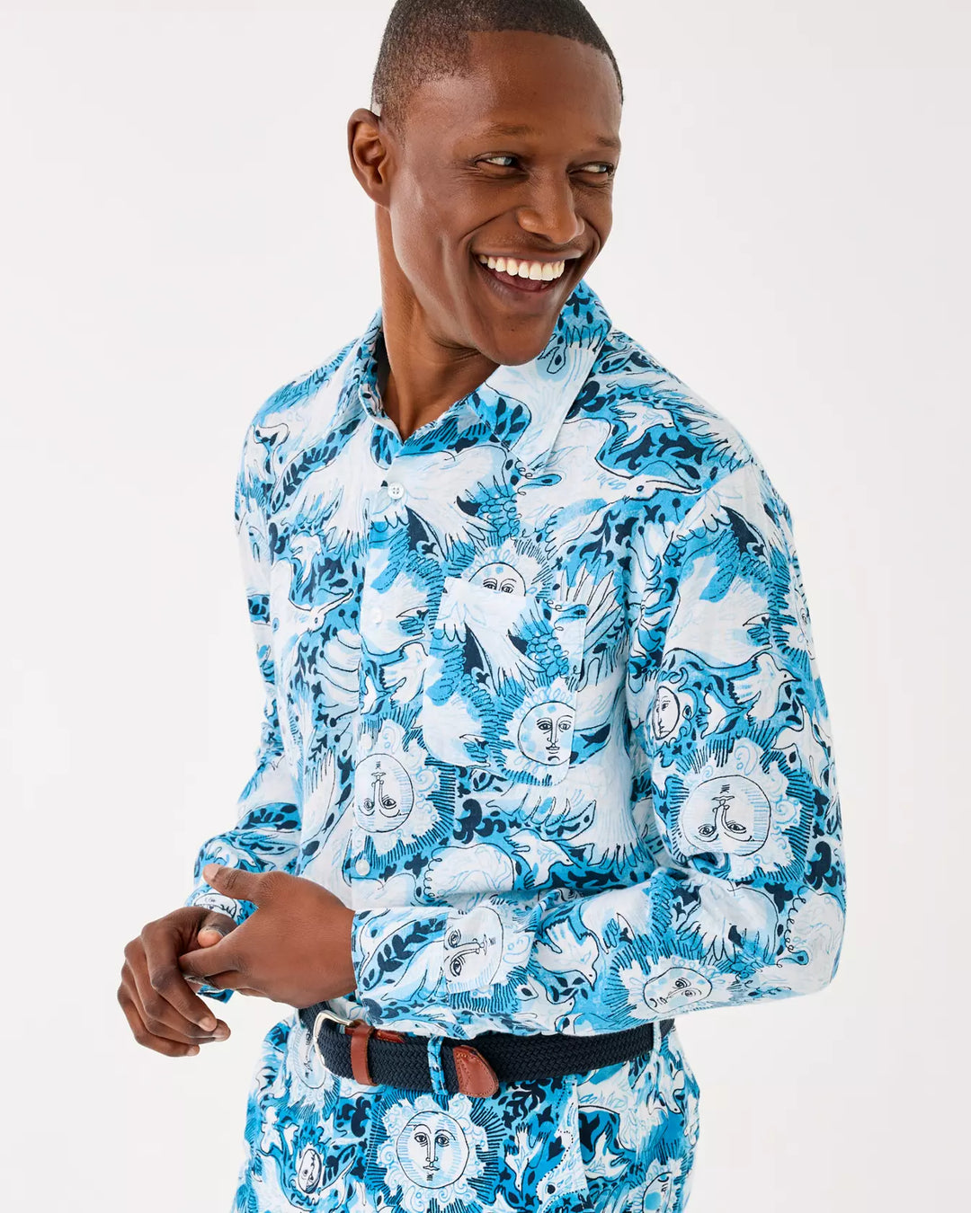 Man wearing a blue and white patterned shirt on a white background