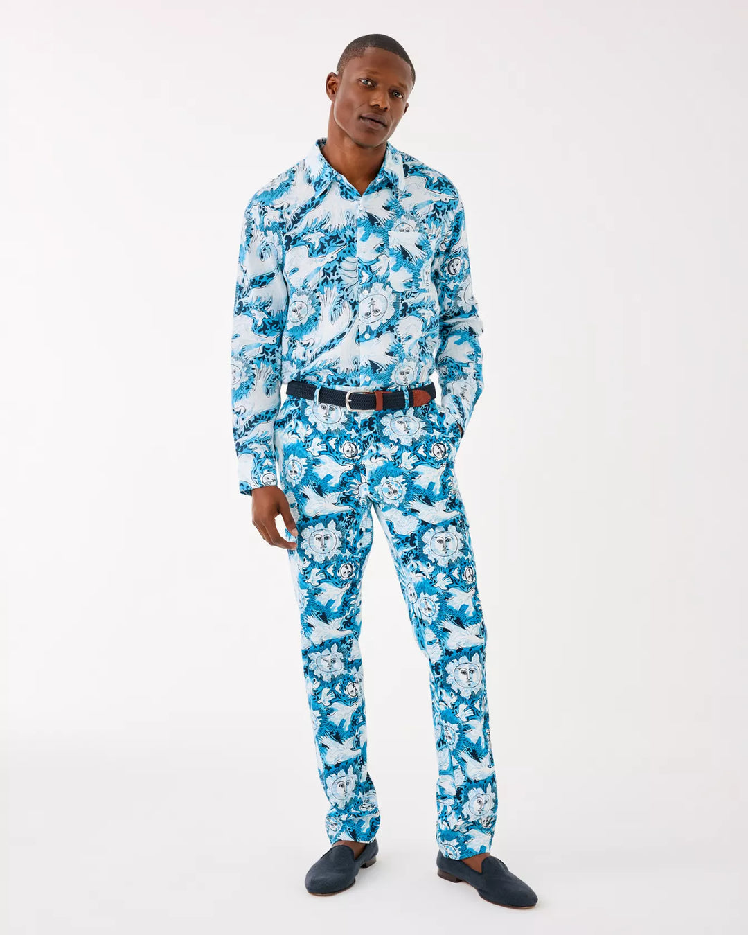 Man wearing a blue floral suit on a white background