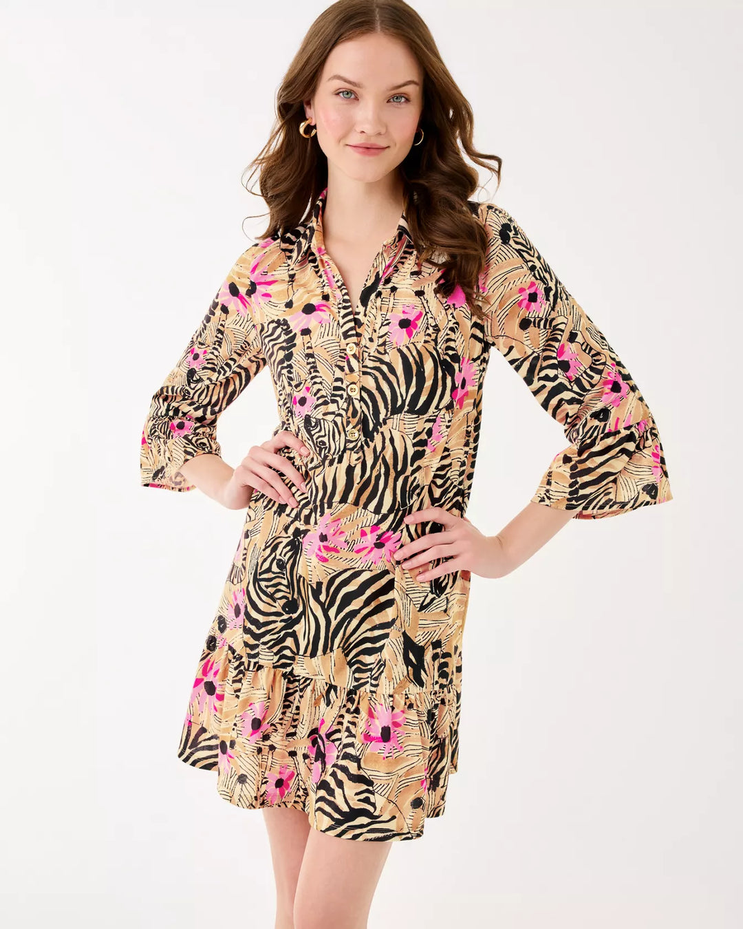 Woman wearing a patterned dress with zebra and floral design on a white background