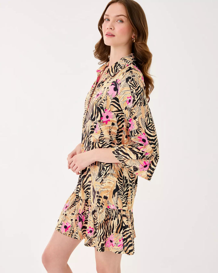 Woman wearing a dress with zebra and floral pattern on a white background