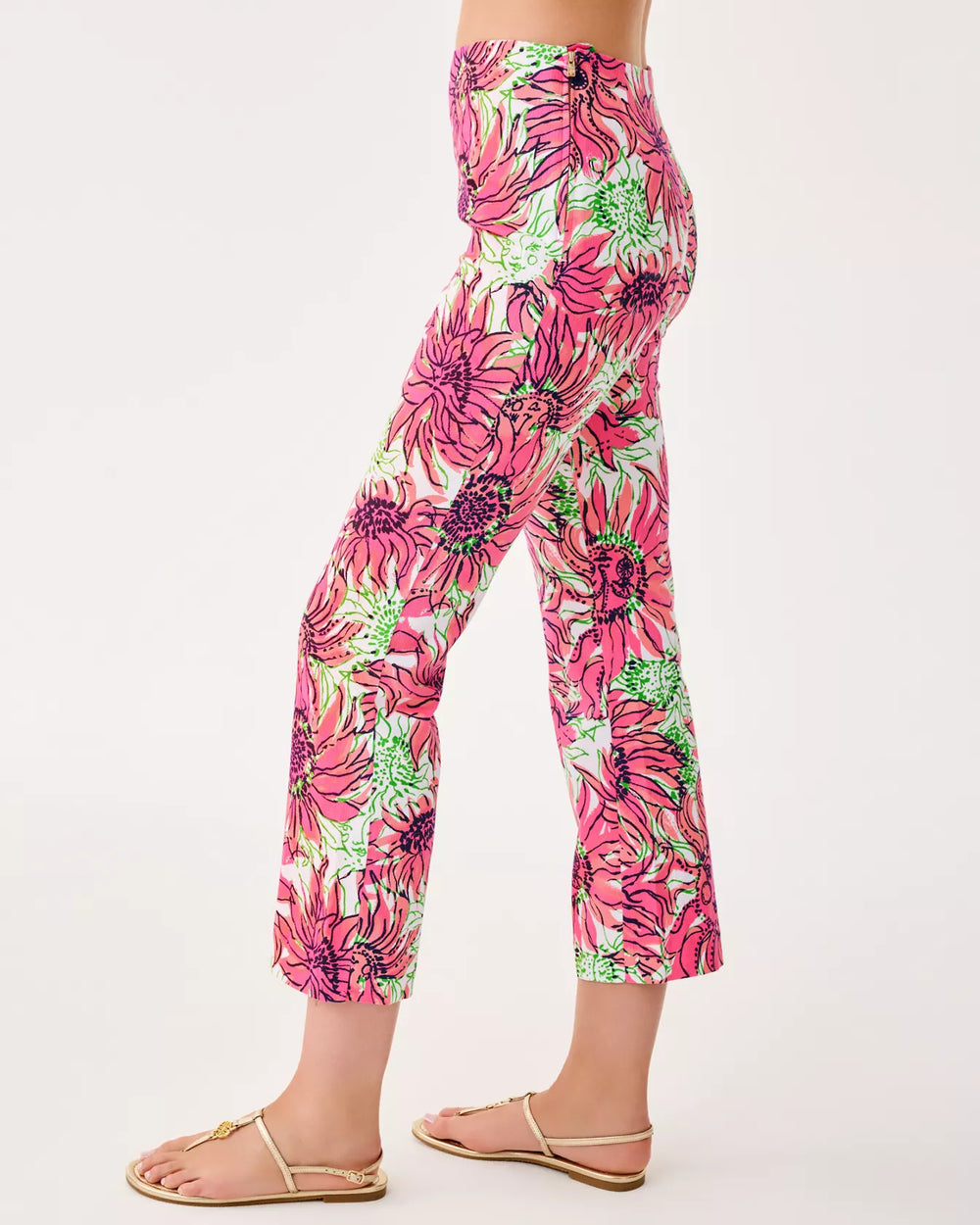 Floral patterned pants worn by a person on a white background