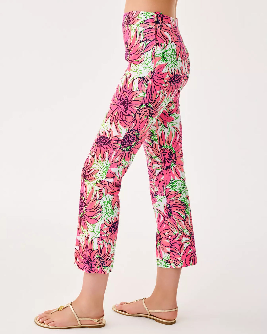 Floral patterned pants worn by a person on a white background