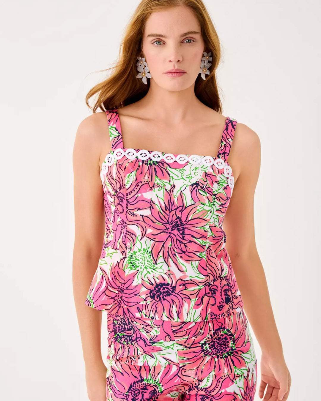 Woman wearing a pink floral dress on a white background