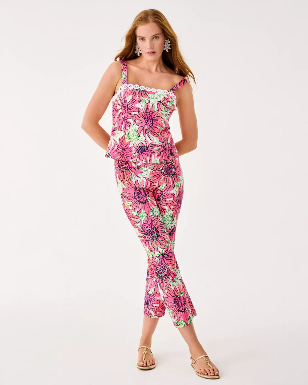 Woman wearing a floral jumpsuit on a white background