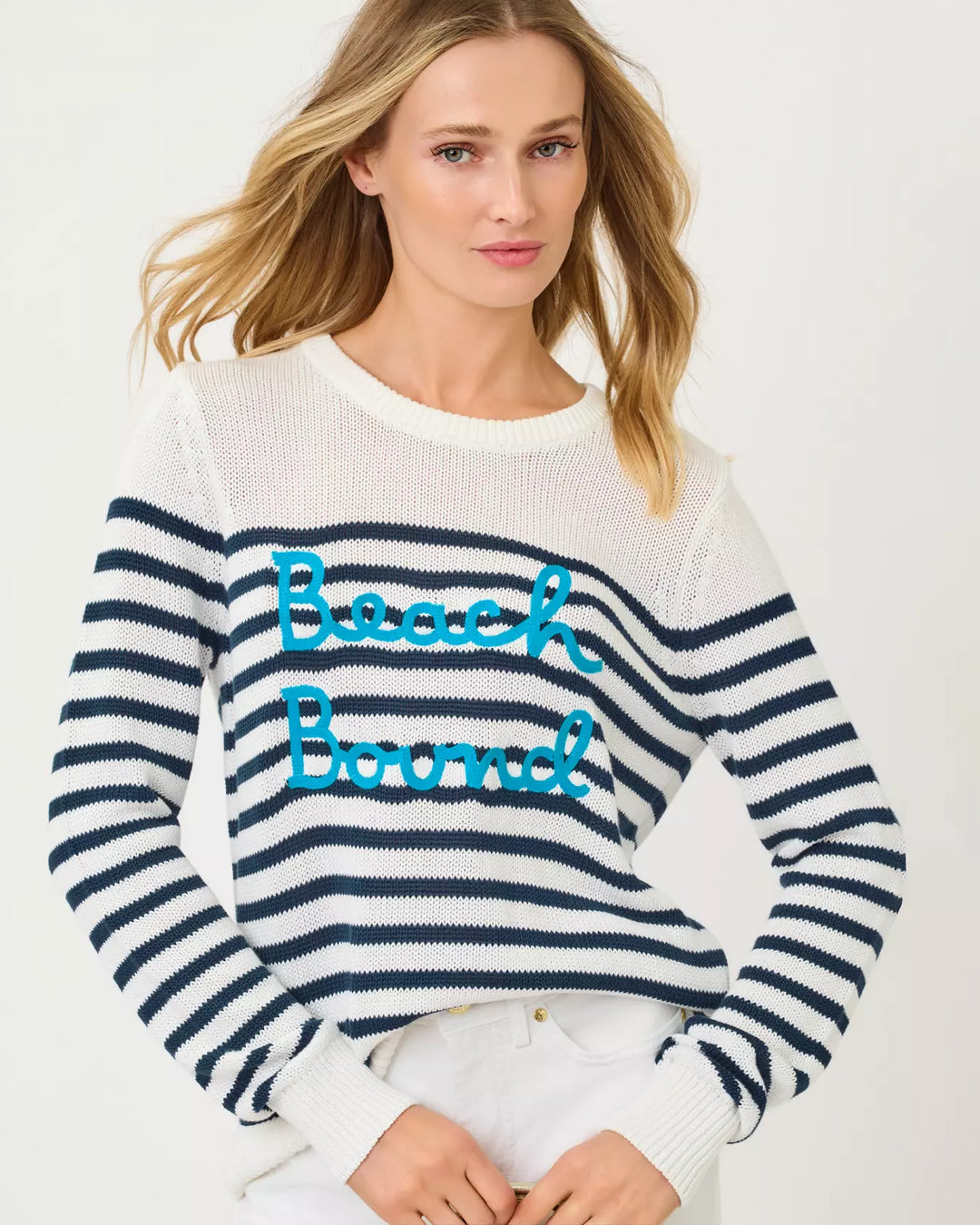 Woman wearing a striped sweater with 'Beach Bound' text on a white background