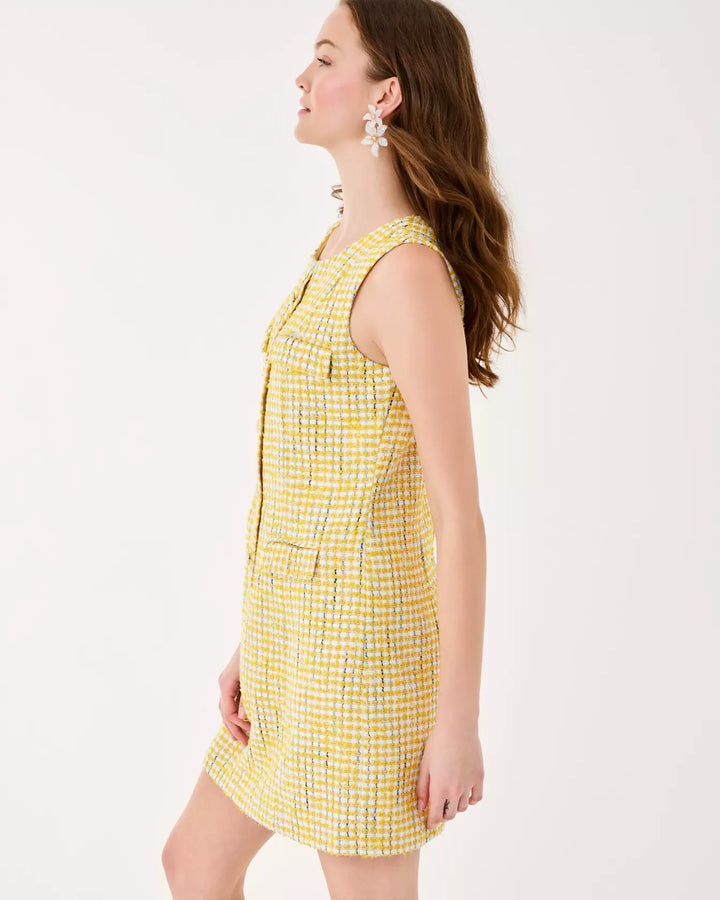 Woman wearing a yellow checkered dress on a white background