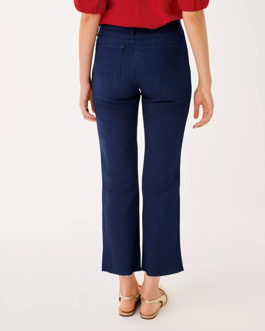 Person wearing navy pants and a red top on a white background