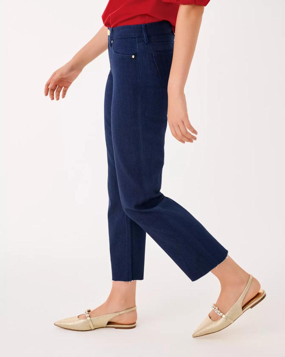 Person wearing navy blue pants and a red top on a white background