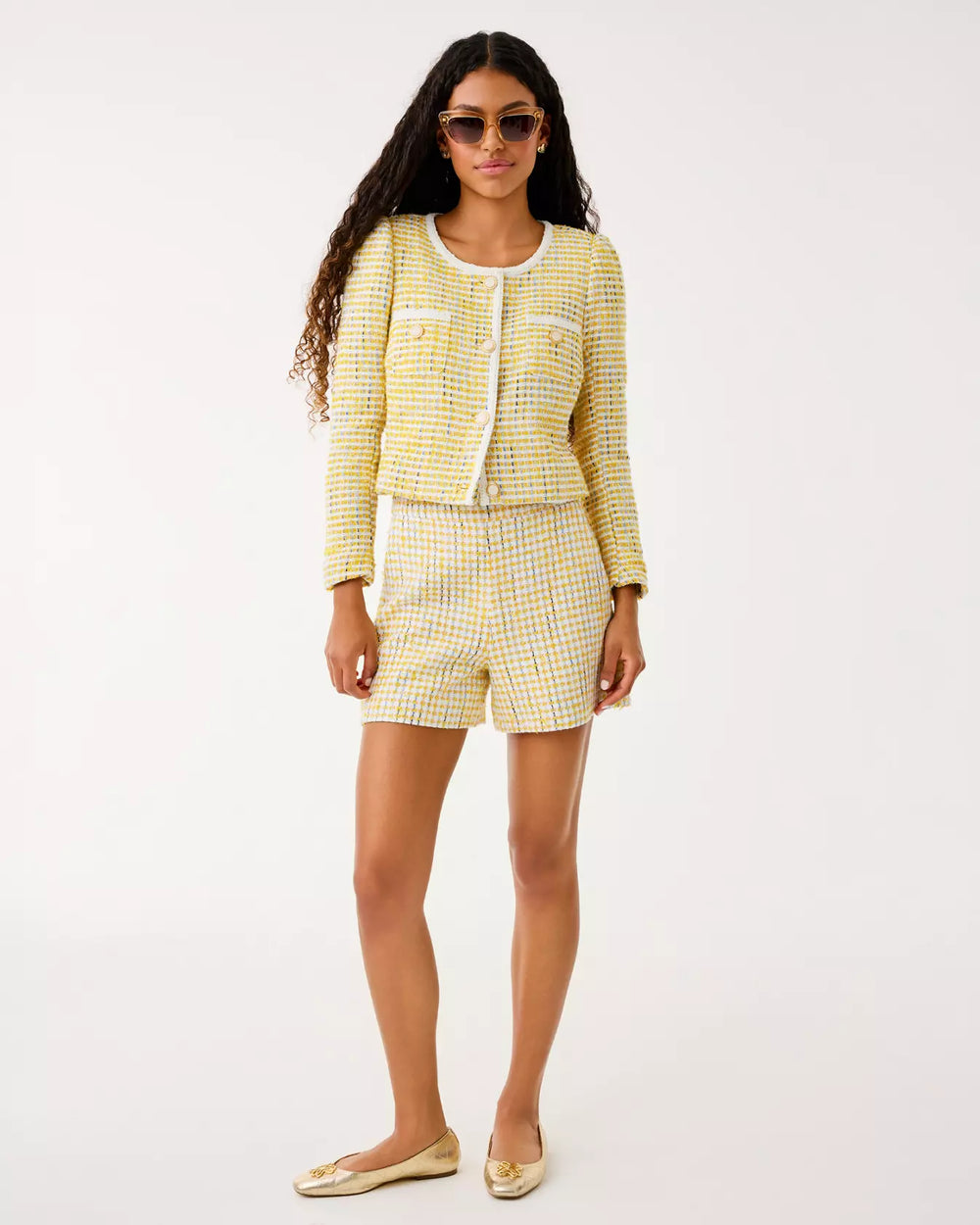Woman wearing a yellow checkered outfit on a white background