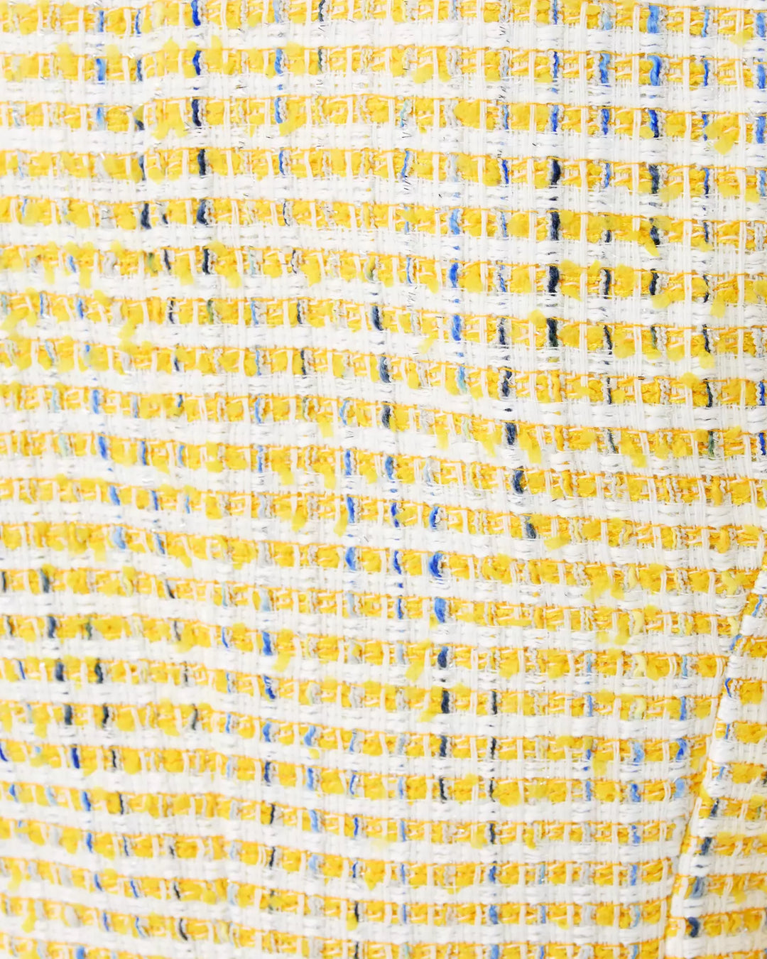 Close-up of a textured fabric with yellow and blue pattern