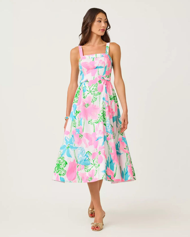 Woman wearing a colorful floral dress on a white background