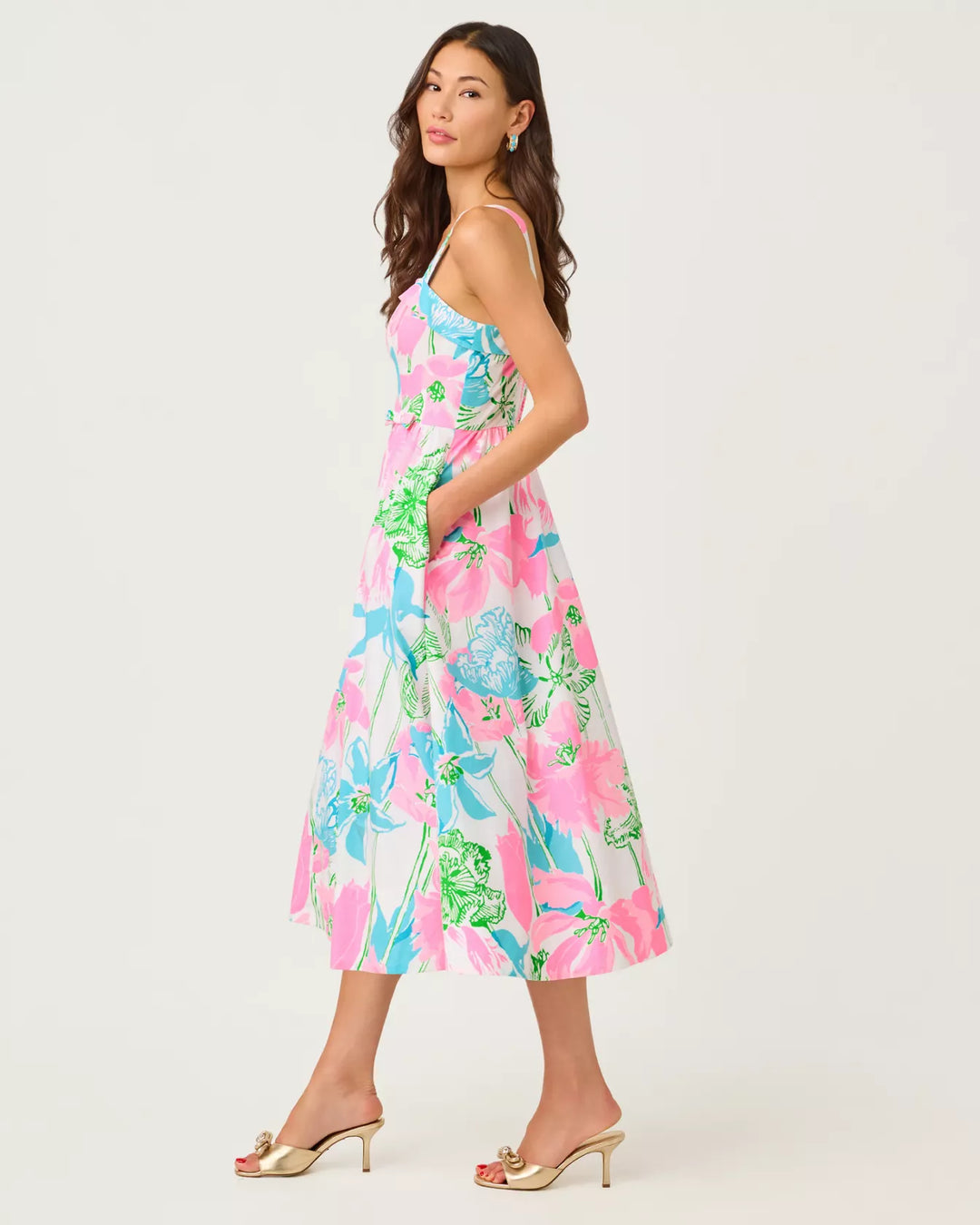 Woman wearing a colorful floral dress on a white background