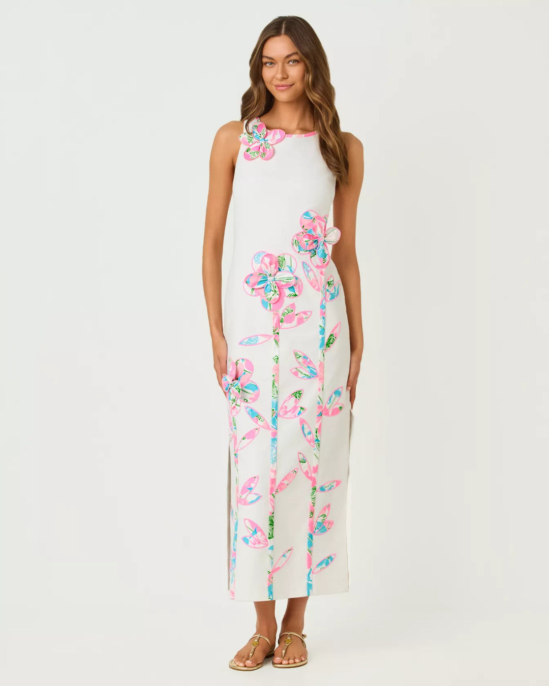 Woman wearing a white dress with colorful floral patterns on a white background