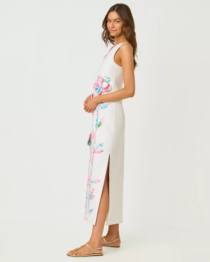 Woman wearing a white sleeveless dress with colorful floral patterns on a white background