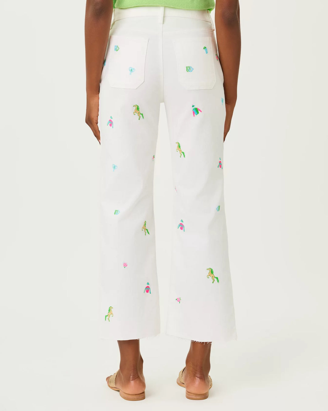 White pants with colorful embroidery on a white background